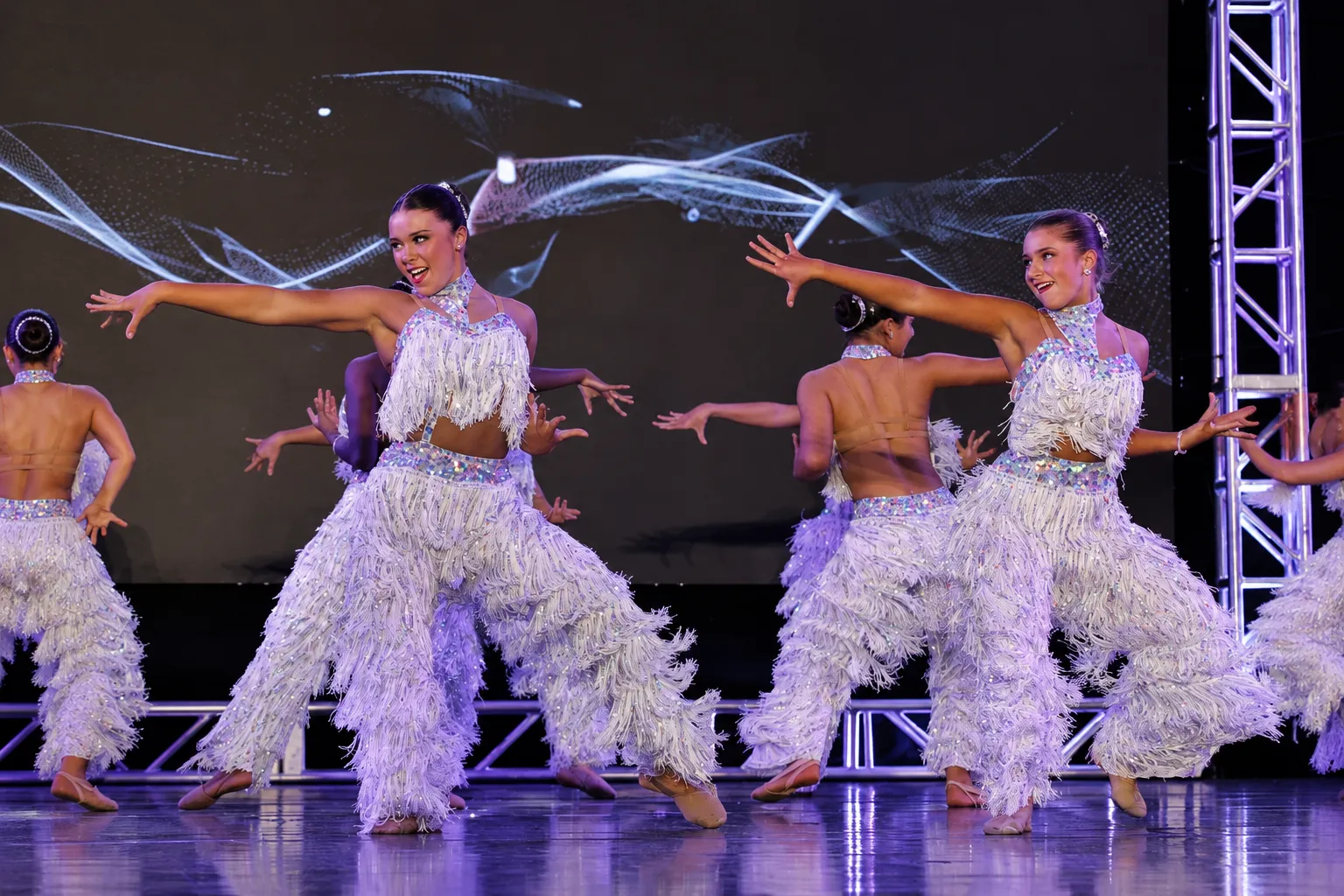 Tari's dancers performing together on stage